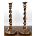 Pair of oak barley twist candlesticks, on turned circular bases, 12.5" high