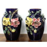Pair of large majolica glazed baluster vases, with applied roses on an ink blue ground, 15" high
