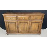 Antique style oak dresser base, with three short drawers over three panelled cupboard doors