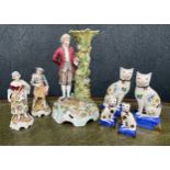 Large decorative German figural porcelain candlestick, modelled with a classically dressed gentleman