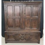 Good antique oak press cupboard, with panelled doors enclosing an open interior with tack hooks,