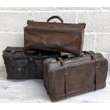 Three items of vintage leather luggage, including a holdall with two buckle pockets, 23" wide, 9.