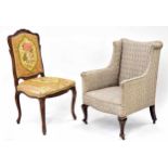 Upholstered wing salon armchair upon cabriole front legs terminating in castors, 24" wide, 25" deep,