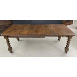 Late Victorian/Edwardian oak winding extending dining table, on barley twist carved legs terminating