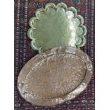 Large oval hammered copper tray, 30" wide; together with a lobed circular engraved brass tray (2)