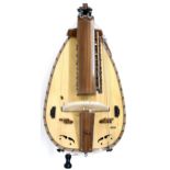 Contemporary boat shaped six string hurdy-gurdy, within a Fusion Cases gig bag