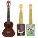 Two Tinkulele upcycled tin ukuleles, with soft bags; together with a Lanikai LU-22TS ukulele, gig