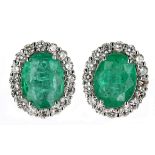 Pair of 18ct white gold modern oval emerald and diamond cluster stud earrings, the emeralds 3.30ct