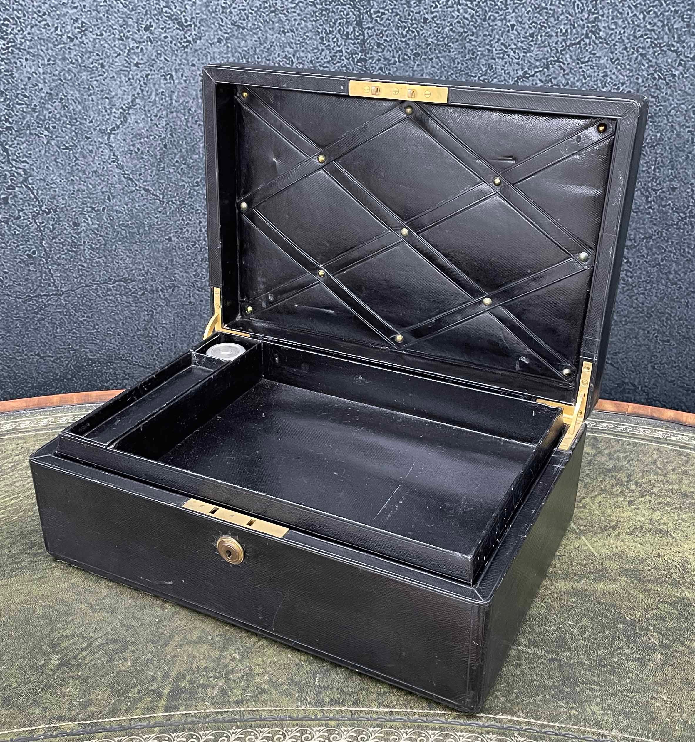 Early 20th century leather bound travelling stationery case, the hinged cover with recessed brass