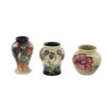 Three miniature Moorcroft Pottery vases, including a 'Hepatica' vase designed by Emma Bossons, a