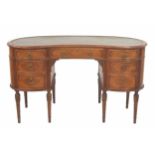 Good French style kidney shaped desk, the top with a green tooled green leather inset, over a