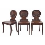 Three Regency scallop shell carved mahogany hall chairs in the manner of Gillows, 17.5" wide, 17"