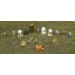 Treen miniature tape measure in the form of a fishing reel; together with a selection of thimbles,