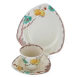 Clarice Cliff 'Passion Fruit' trio, comprising a tea cup, saucer and side plate, the side plate 7.