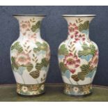 Pair of large decorative pottery vases, with relief decorated lily flower decoration on a pale