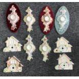 Six various painted porcelain rococo cartouche watch holders, 9" high (three with velvet backing and