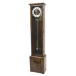 Oak electric longcase clock, bearing a rectangular brass plaque fixed to the inside back of the case