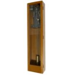 Electric master wall clock, within a light oak glazed case, 50.5" high (pendulum and bob)