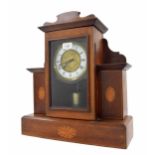 Unusual electric mantel clock, the 5" white chapter ring enclosing a foliate embossed centre, within