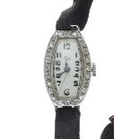 1920s platinum diamond set lady's cocktail wristwatch, oval silvered dial signed Las, tonneau case