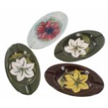Four Moorcroft Pottery oval trinket trays, each 6.25" x 3.5"; together with three triangular