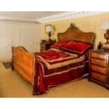 Impressive French walnut carved double bed frame, the headboard with carved leaf scroll finial,