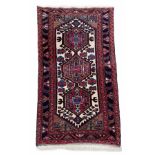 Small Afghan Heriz type rug, on a red ground, 53" x 30" approx