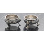 Similar pair of George II silver cauldron salt cellars, each repousse decorated with C scroll