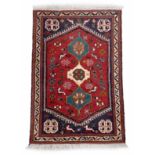 Small Persian rug on a red ground, 40" x 26.5" approx