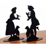 Pair of 'Carolyn Sheffield Designs' metal silhouette figures, each with a dove and sheep by their