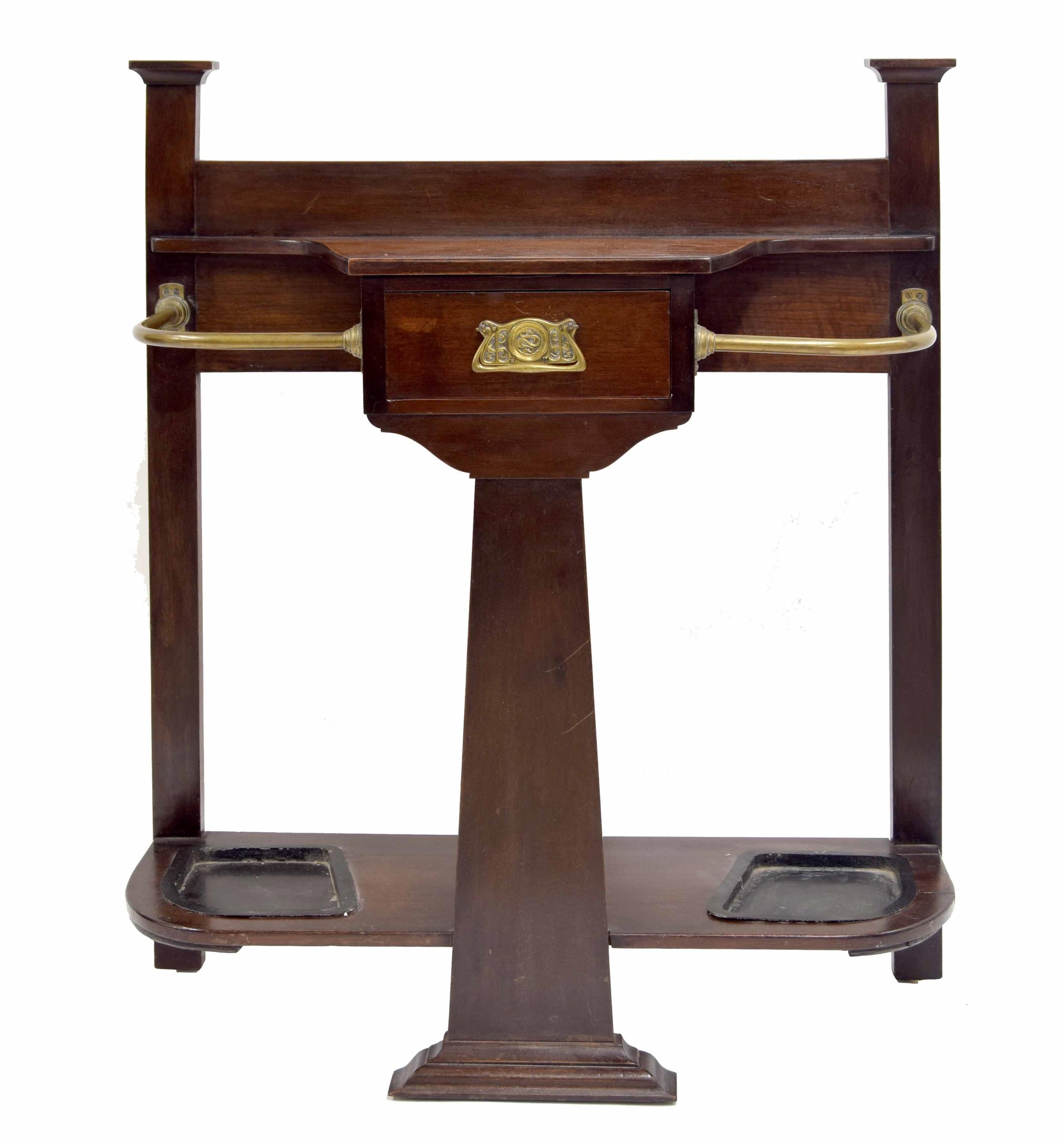 Arts & Crafts mahogany hall stand stamped Maple & Co., with brass rails aside a central slim