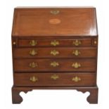 George III mahogany bureau, the hinged fall front inlaid with an oval paterae enclosing a fitted