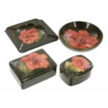 Four pieces of Moorcroft Pottery 'Coral Hibiscus' pottery, to include a square ash tray, 4.5" x 4.