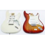 Two Strat type guitar bodies for projects, one fitted with pickguard, electrics and bridge (2)