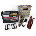 Selection of guitar accessories to include two Hercules guitar neck rests, a Fender guitar lunchbox,