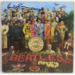 The Beatles - an autographed 'Sgt Pepper's' vinyl record, signed in black pen 'Paul McCartney'