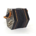 Old German concertina, with twenty buttons on foliate pierced metal ends, six-fold bellows