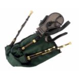 Set of old Northumbrian pipes, unnamed, with brass ferrules and green tartan bag, cased **These