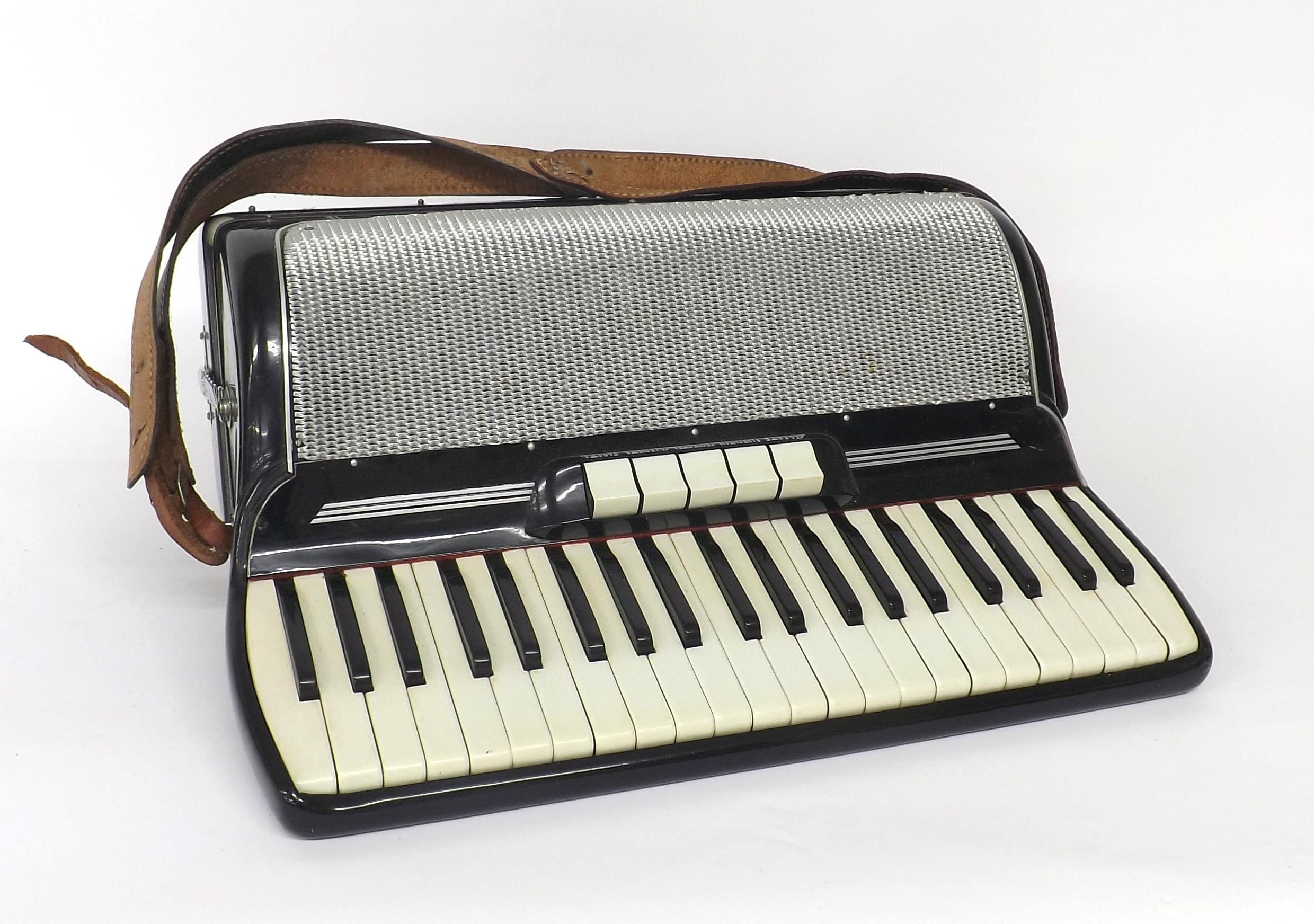 Gaudini piano accordion with one hundred and twenty buttons and five switches, black finish, case