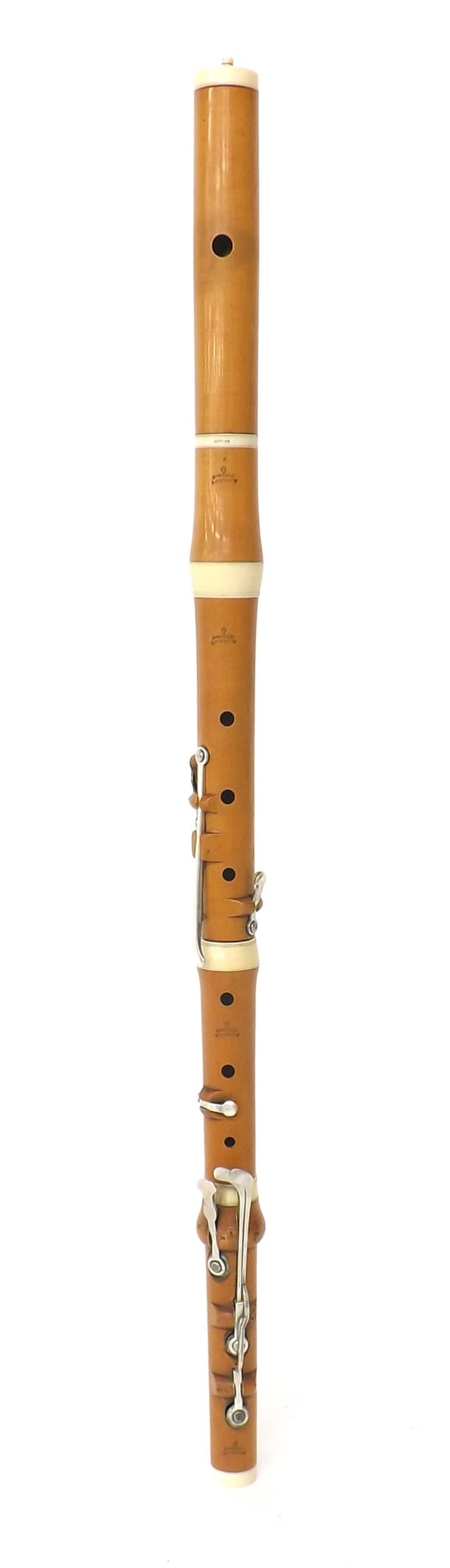 Boxwood and ivory flute by and stamped J. Wood, London, with eight silver keys on wooden blocks,