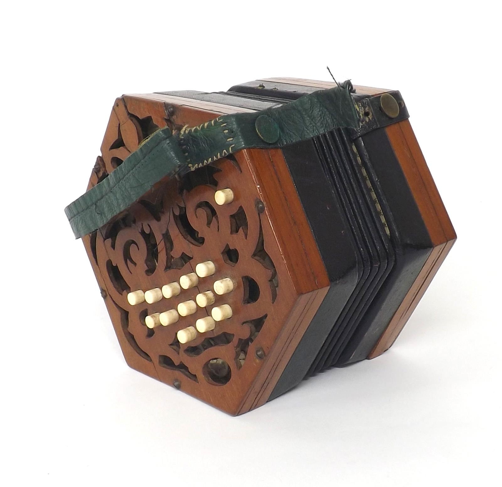 C. Jones concertina in need of restoration, with twenty-seven bone buttons on pierced mahogany ends,