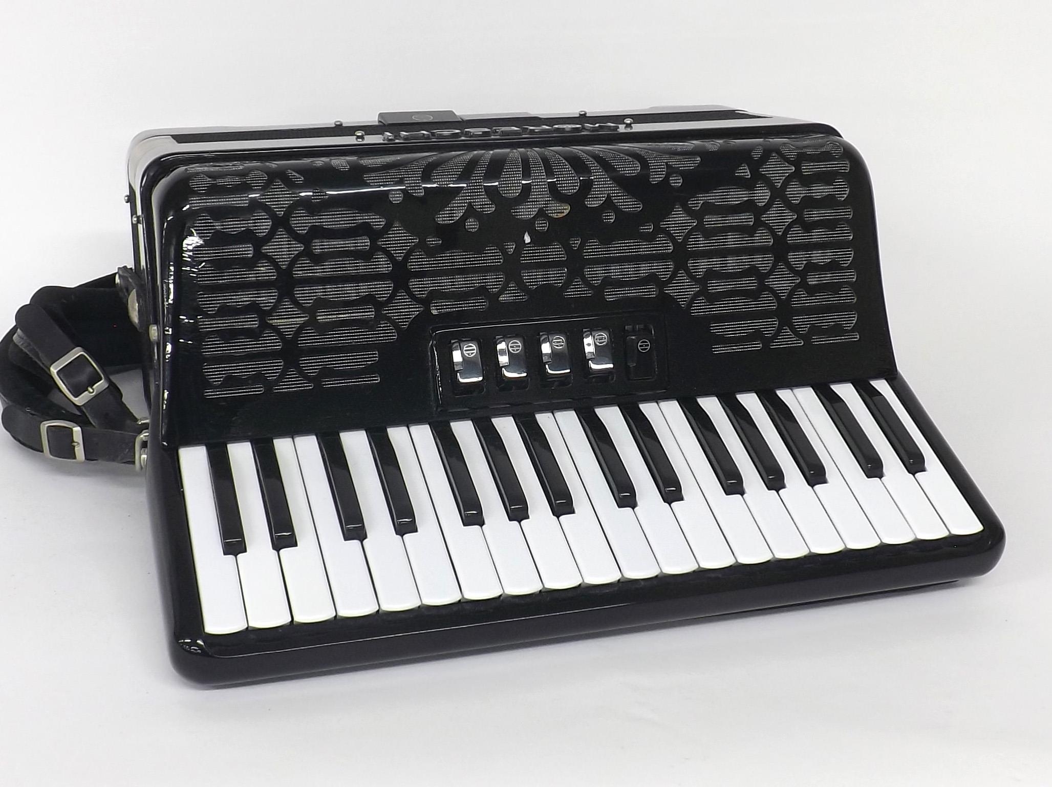 Moreschi piano accordion with seventy-two buttons and five switches, black finish, soft case