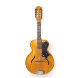 Otwin mandolin with guitar shaped body, maple back and sides and chevron banded spruce table, mother