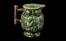 Antique Majolica 'Birds of Prey' Pitcher in dark green finish.