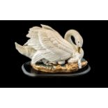 Spanish Porcelain Swan Group, depicting a swan with her chick, mounted on a wooden base. Marked to