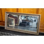 A Rectangular Mirror with Gilt Swept Moulded Frame. Overall size 25" x 45".