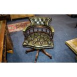 A Modern Leather Swivel Captains Chair green leather button back and seat.