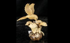 Tagua Nut Amazonian Hand Made Figure, depicting a hummingbird and a flower.