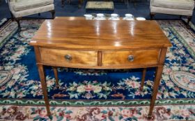 A Mahogany Slight Bow Fronted Side Table, two frieze drawers, raised on tapering legs.