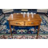 A Mahogany Slight Bow Fronted Side Table, two frieze drawers, raised on tapering legs.